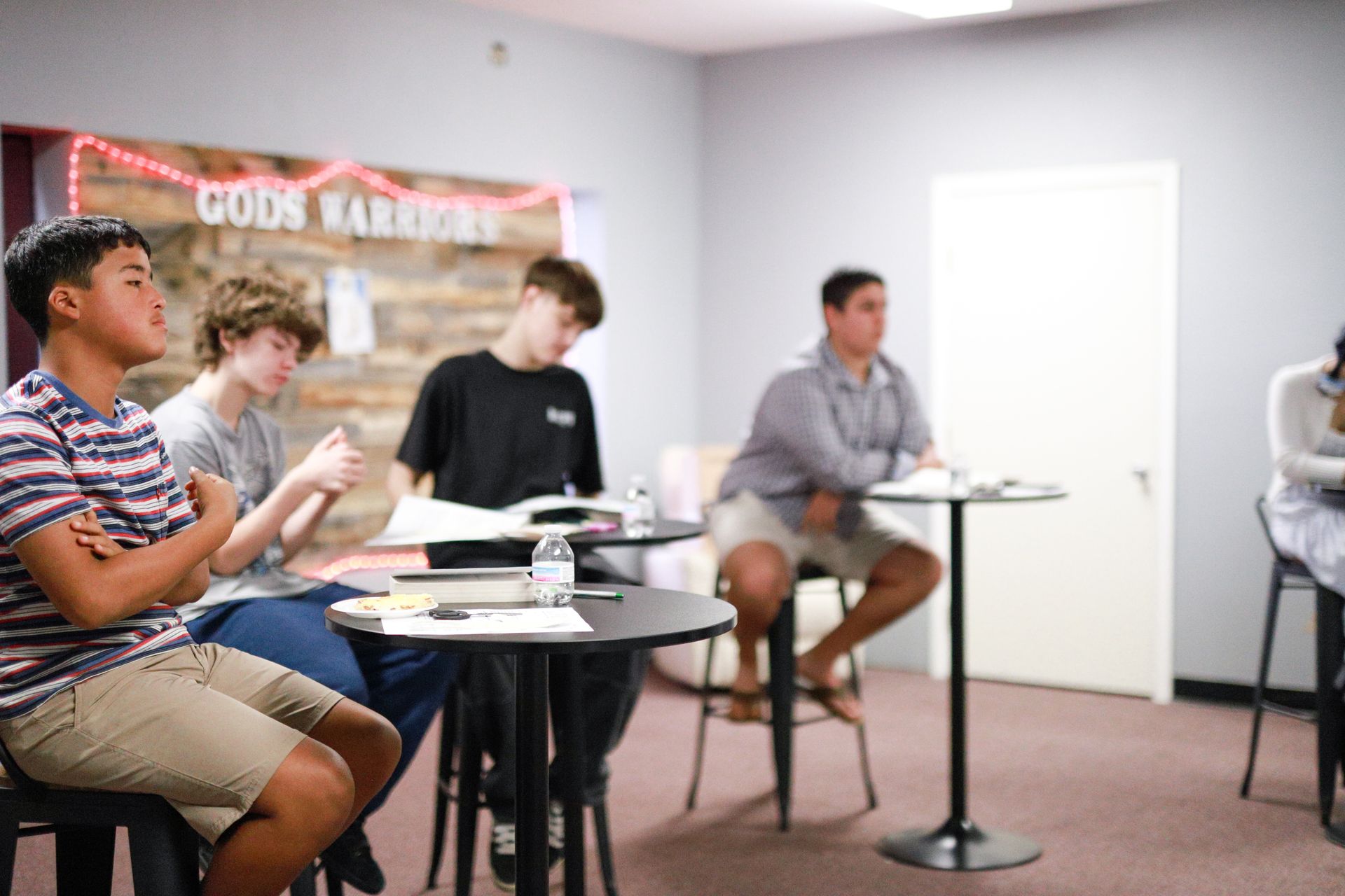 A woman is sitting on the floor reading a book
