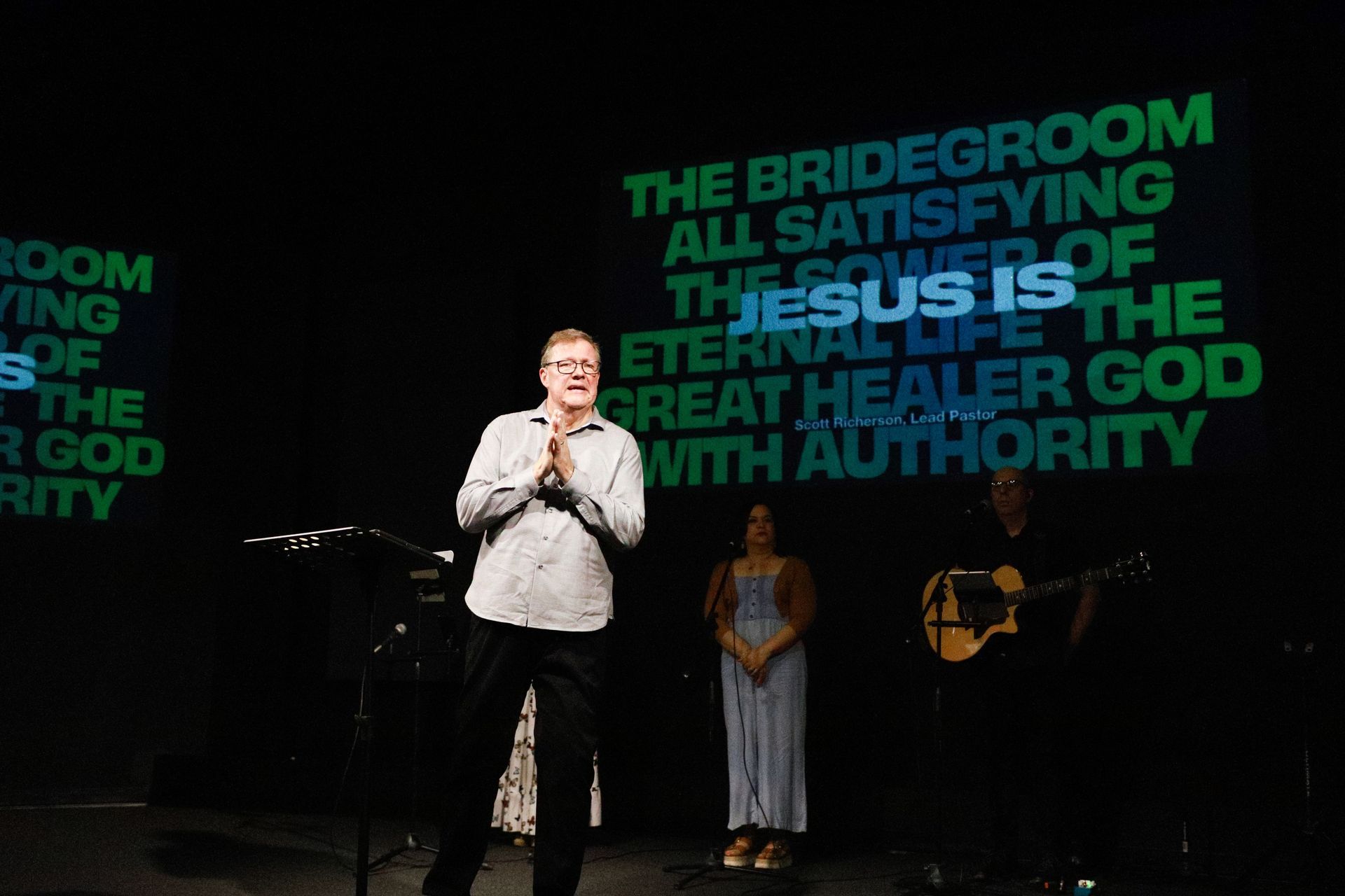 A woman is sitting on the floor reading a book.