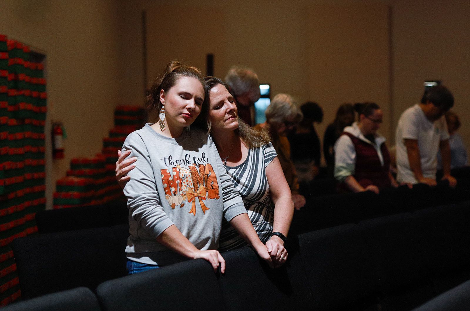 A woman and a little girl are standing next to each other holding maracas.