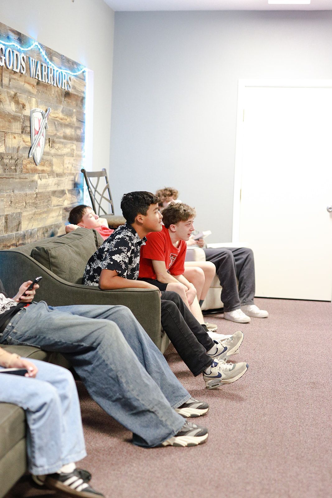 A group of people are posing for a picture in front of a body of water.