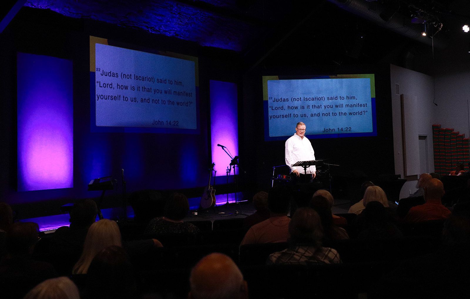 A group of people are posing for a picture in front of a body of water.