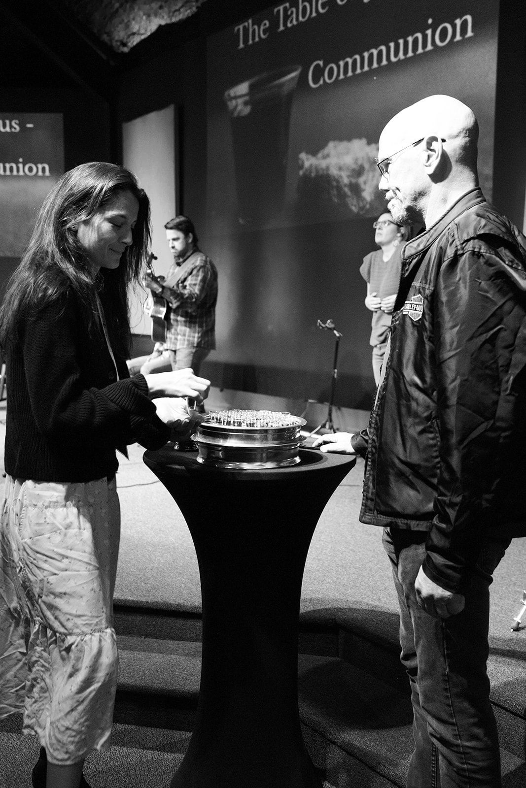A person is reading a bible in a black and white photo.