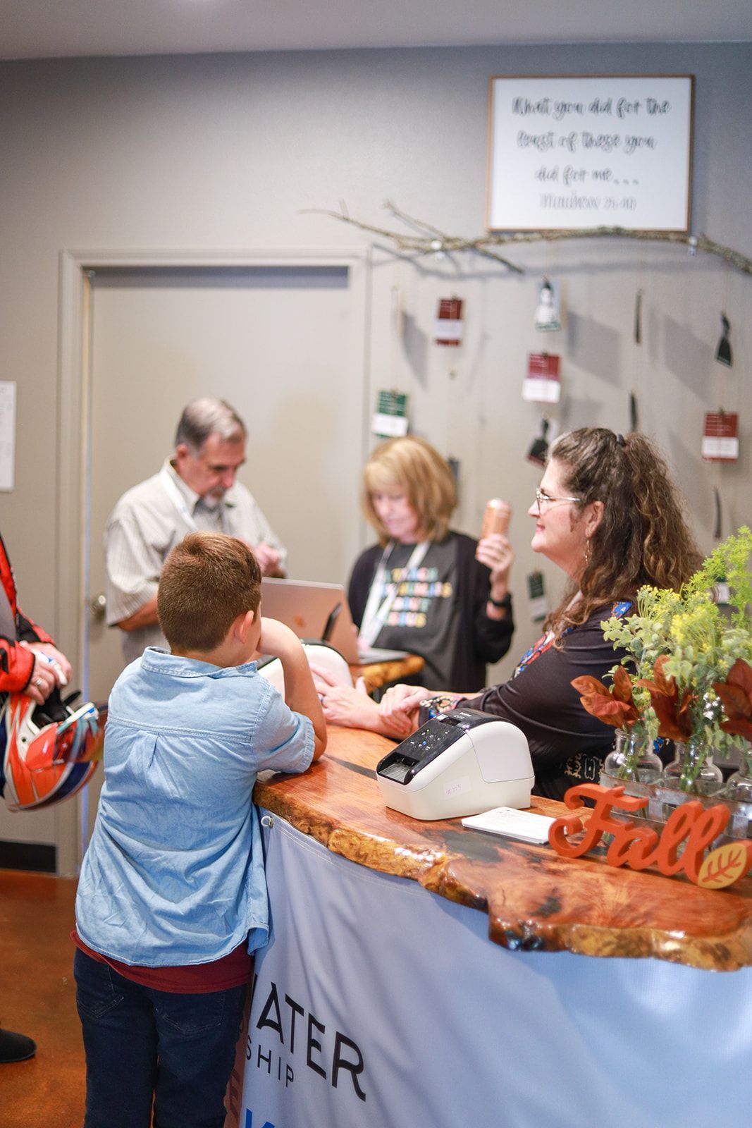 A group of people are standing around a counter in a store.
