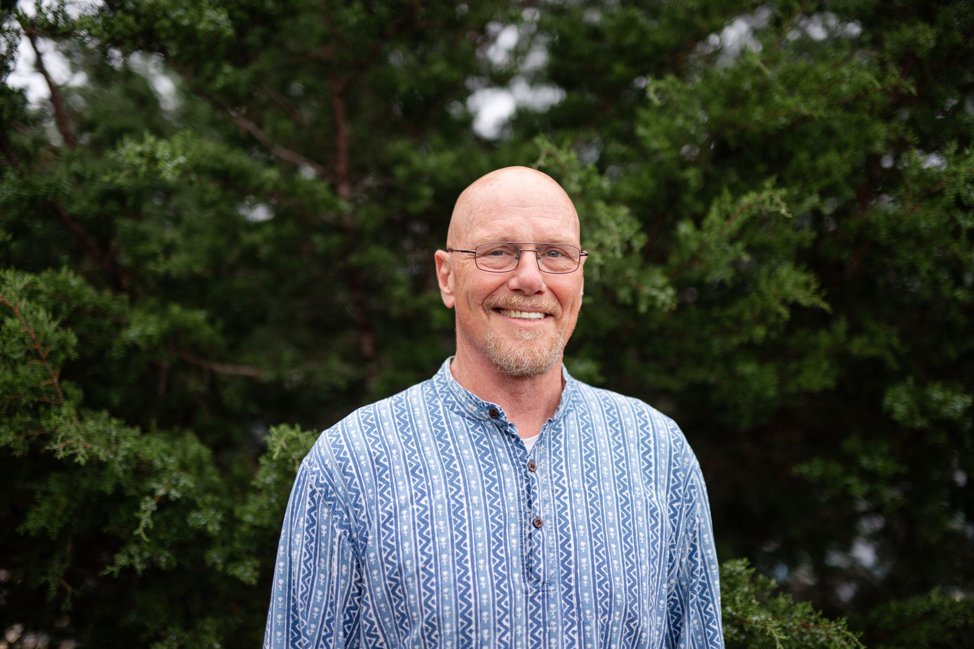 A man and a woman are posing for a picture and the man is wearing a shirt that says genuv