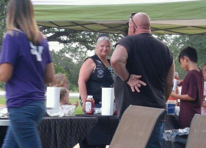 A woman in a purple shirt has the letter y on her back