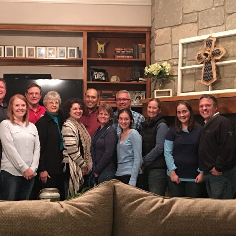 A group of people posing for a picture in a living room