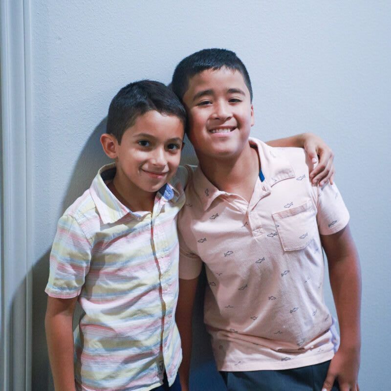 Two young boys are posing for a picture together