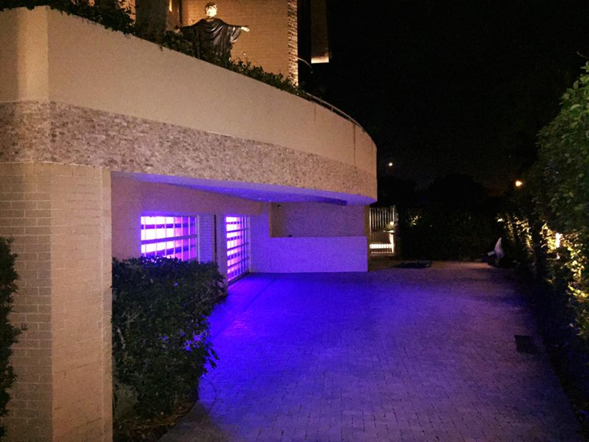 A purple light is shining on a building at night