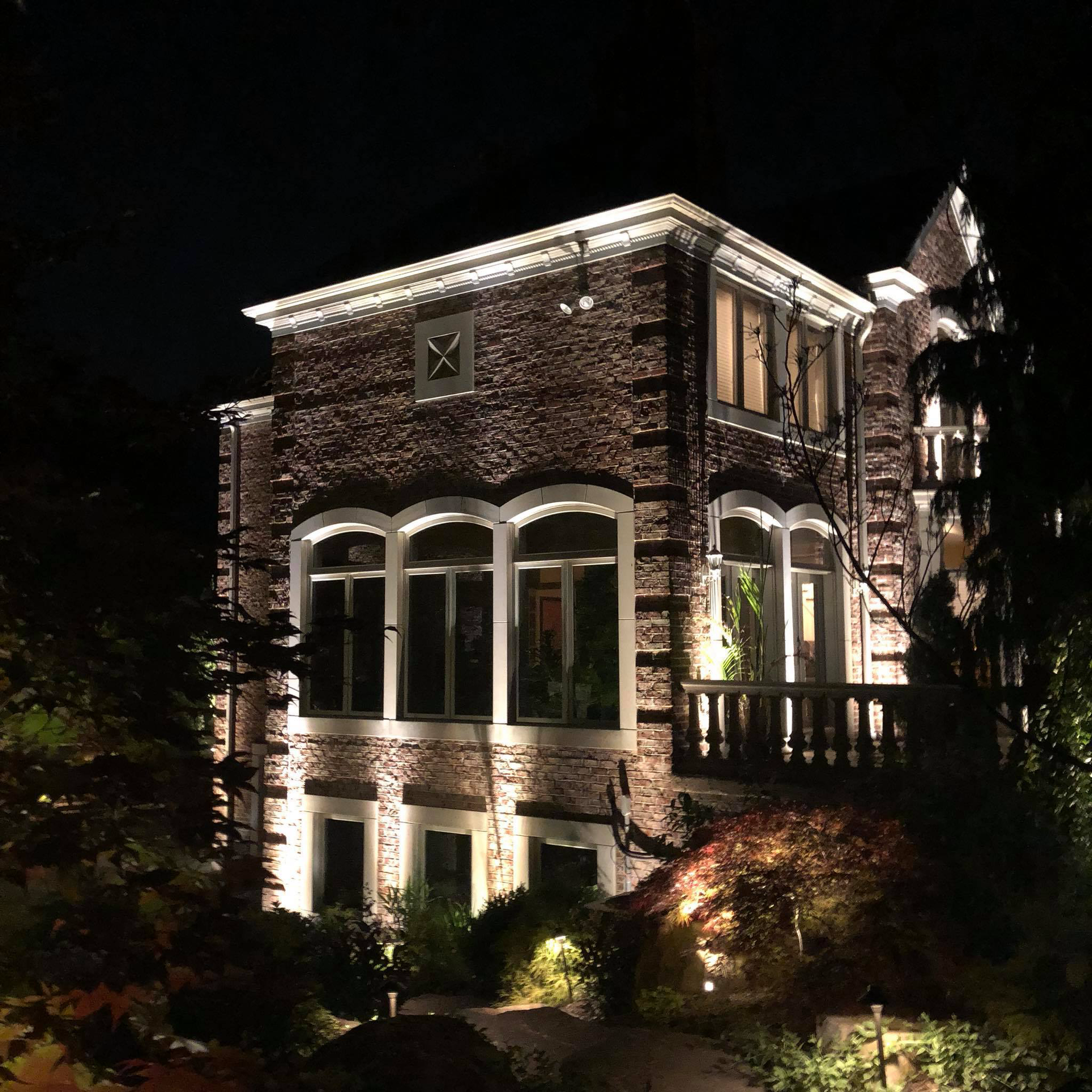 A large brick building is lit up at night