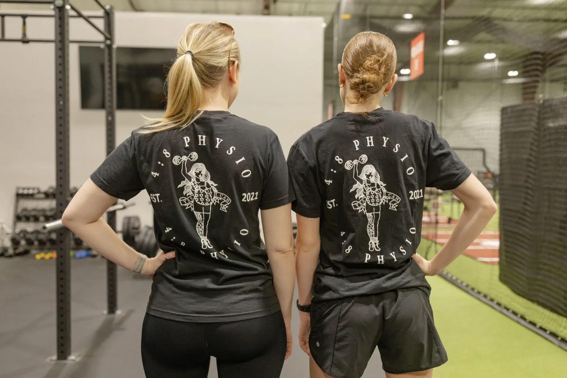 Women wearing 4:8 Physio strength shirts in the gym