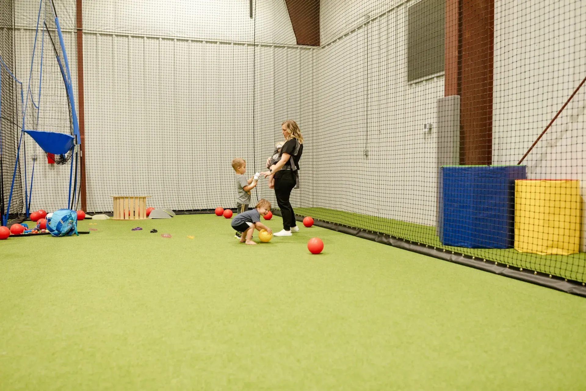 A child smiling in the childcare area at 4:8 Physio