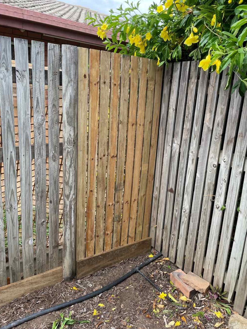 A Wooden Deck With A Metal Railing And A Fence — FNQ Maintenance Services In Parramatta Park, QLD