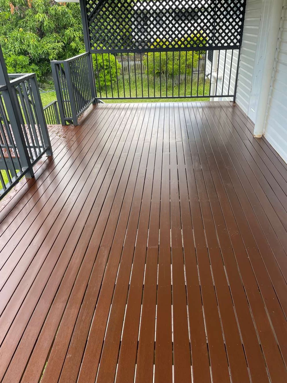 A Wooden Deck With A Metal Railing And A Fence — FNQ Maintenance Services In Parramatta Park, QLD