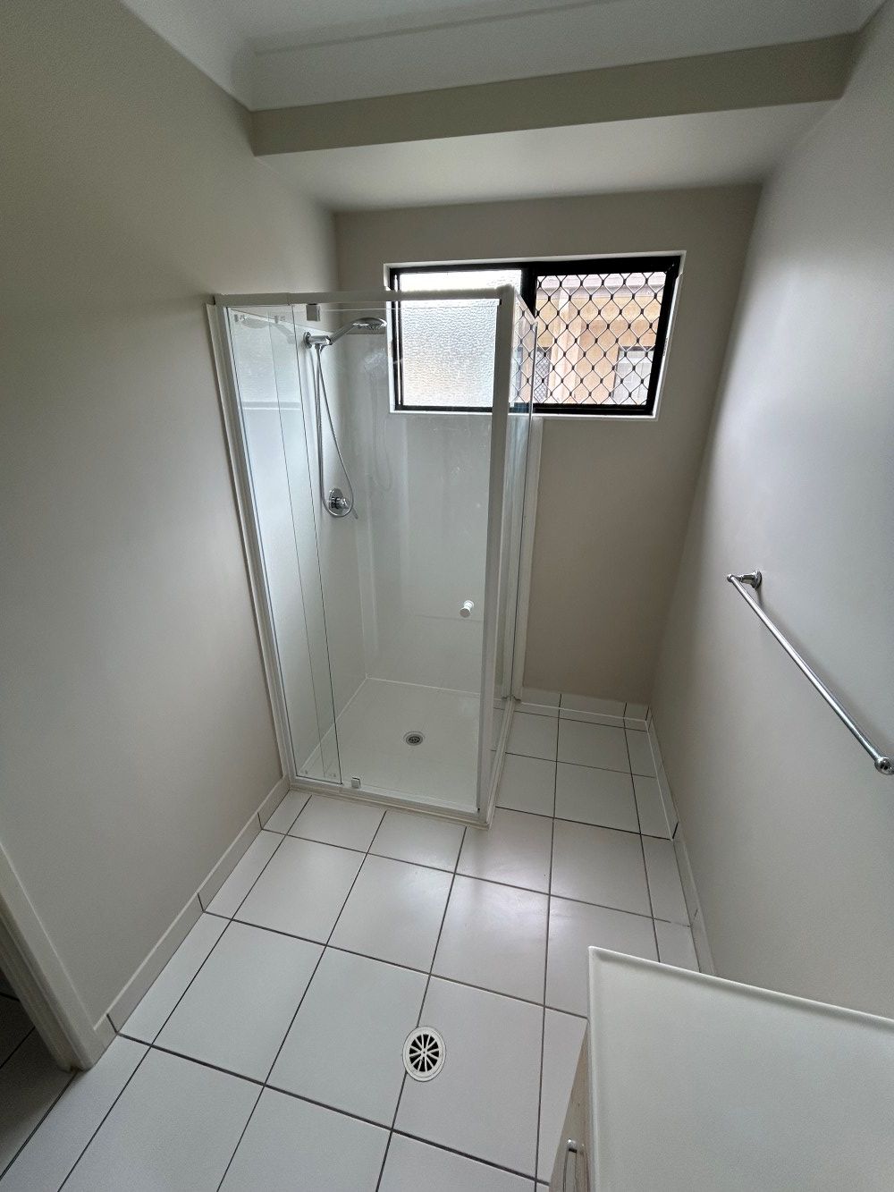 A Bathroom With A Walk In Shower And A Window — FNQ Maintenance Services In Parramatta Park, QLD