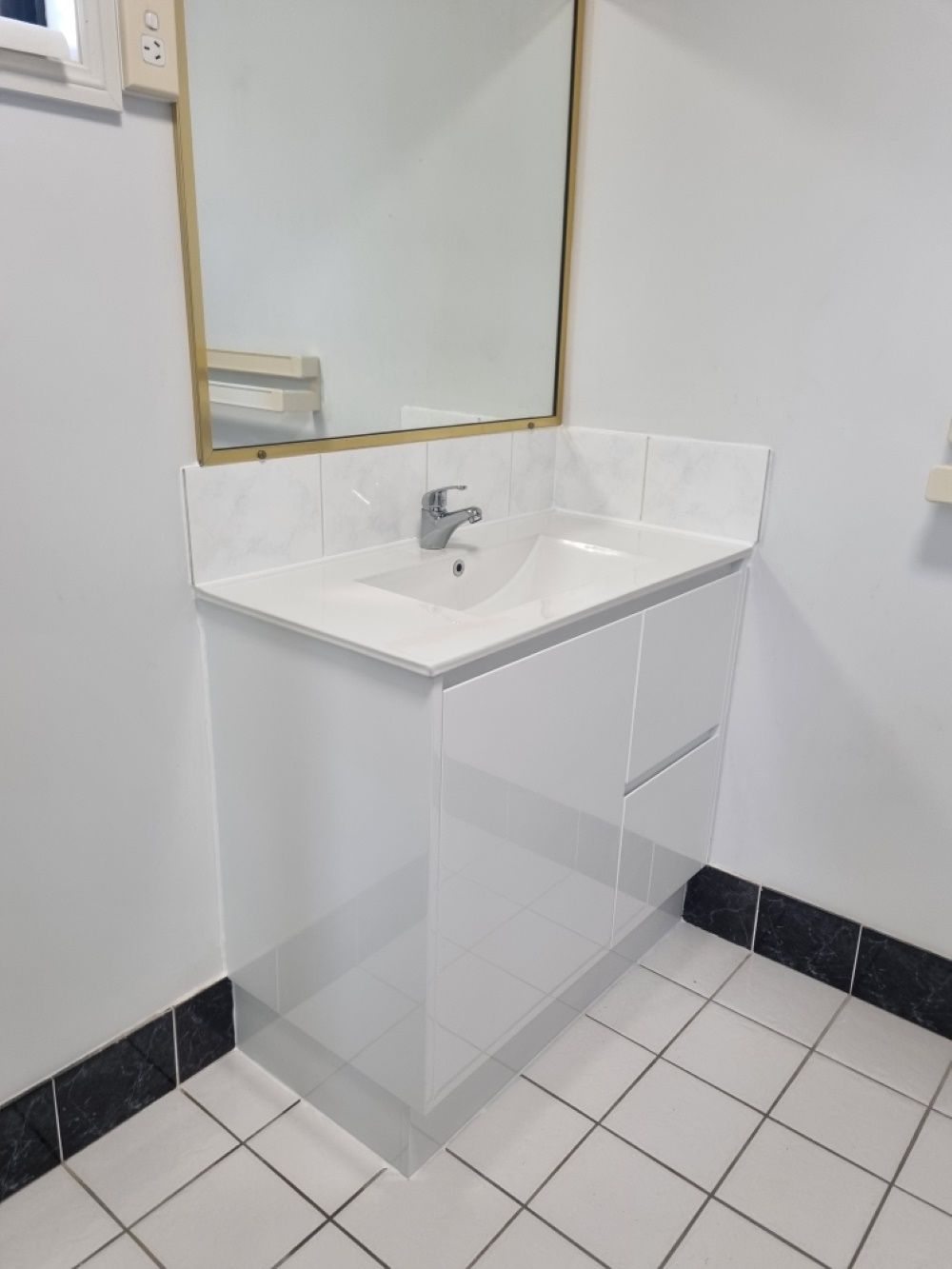 A Bathroom With A Sink , Mirror And Tile Floor — FNQ Maintenance Services In Parramatta Park, QLD