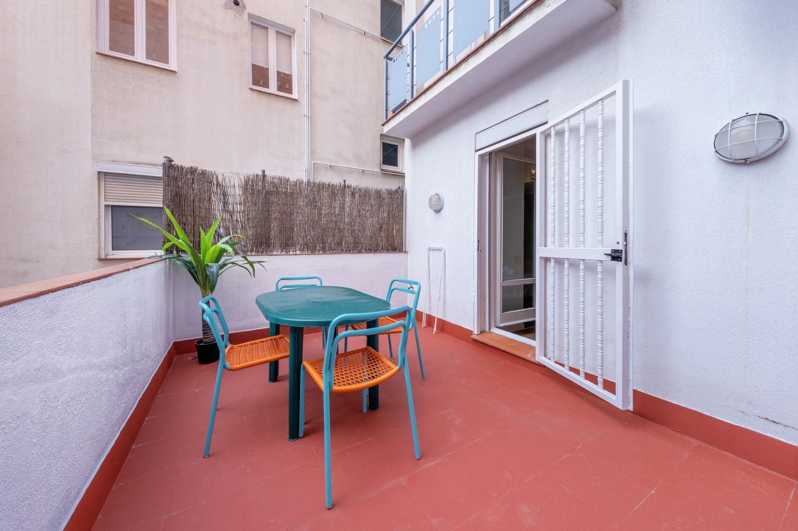 A balcony with a table and chairs on it