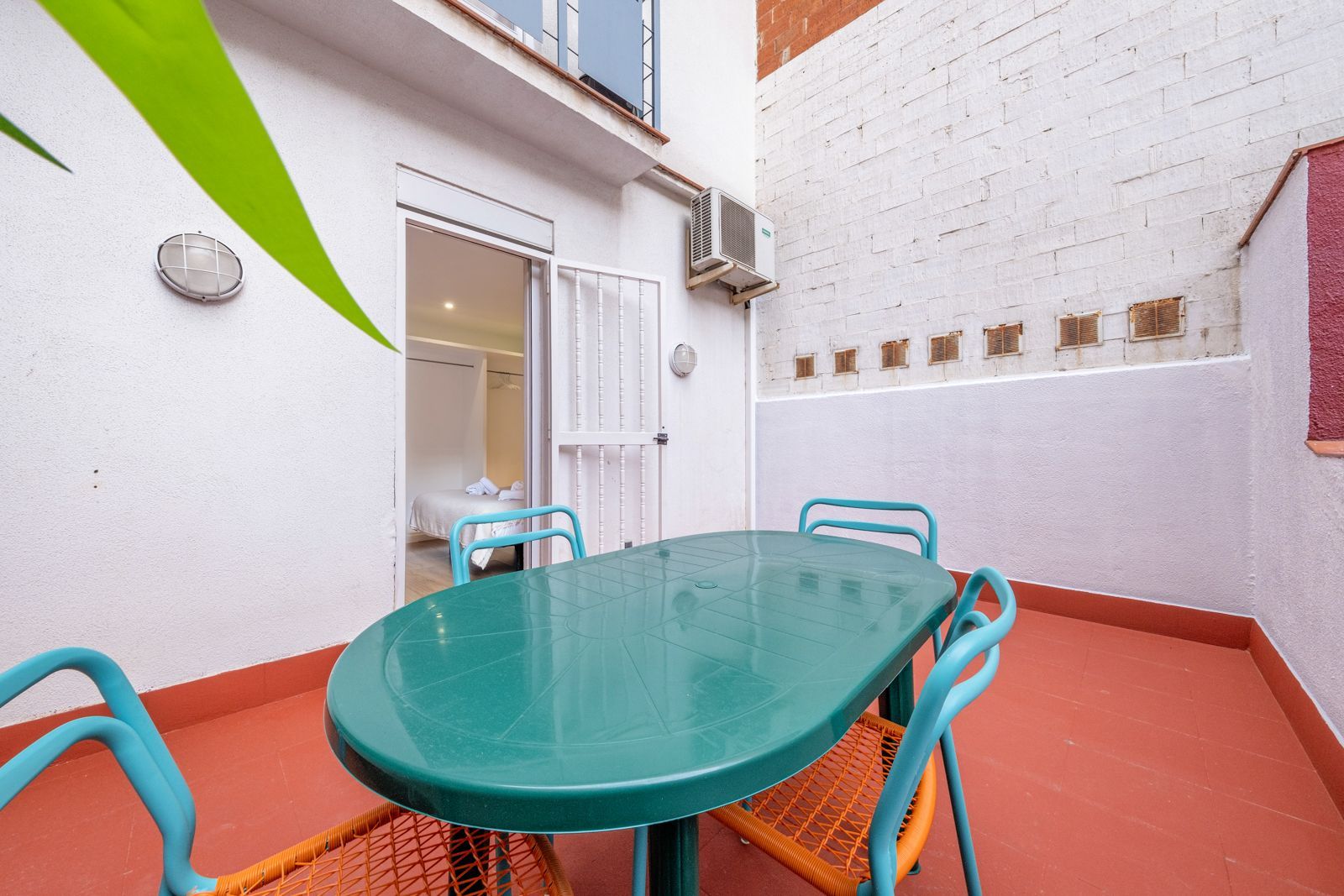 A small patio with a green table and chairs