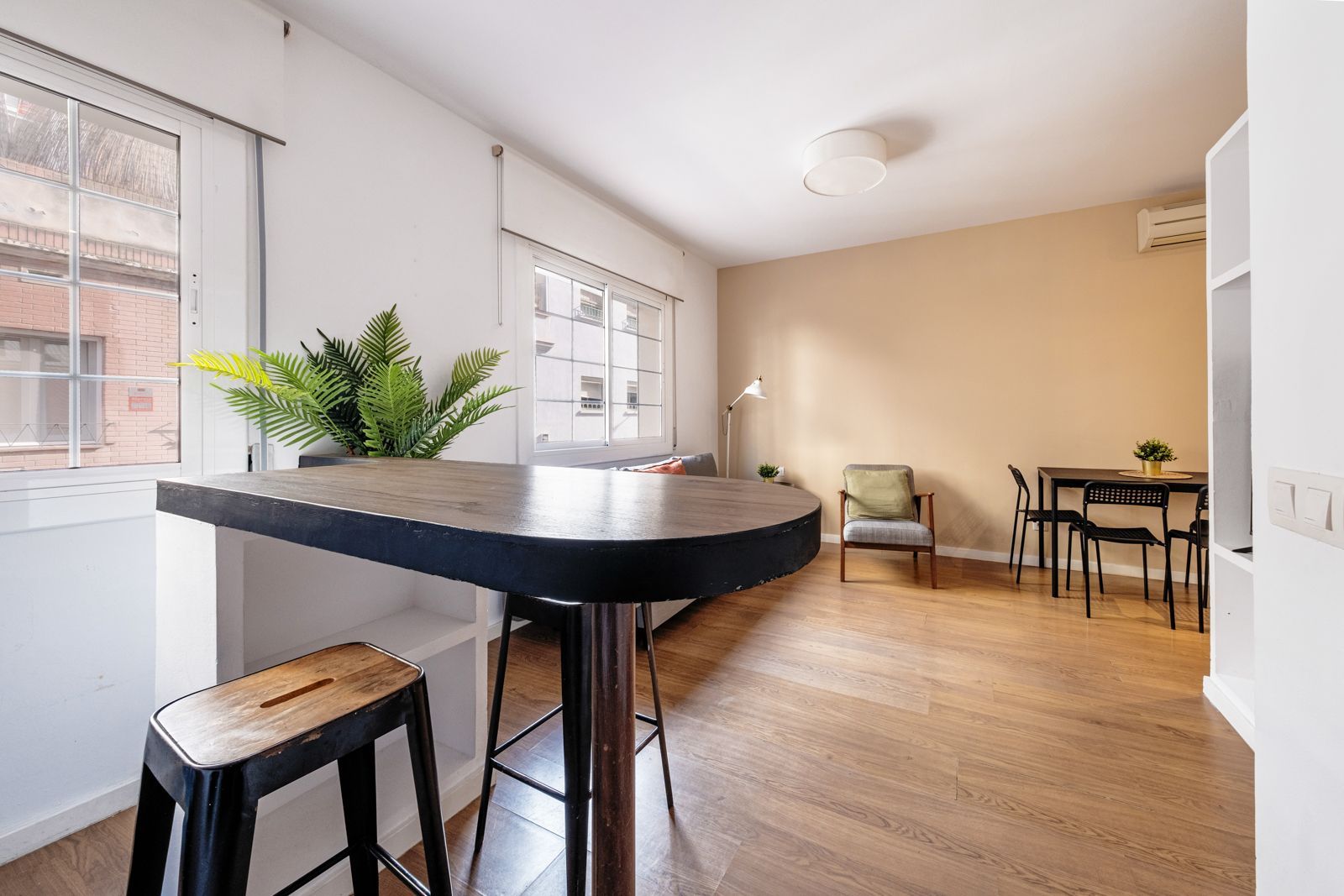 A living room with a table and chairs in it
