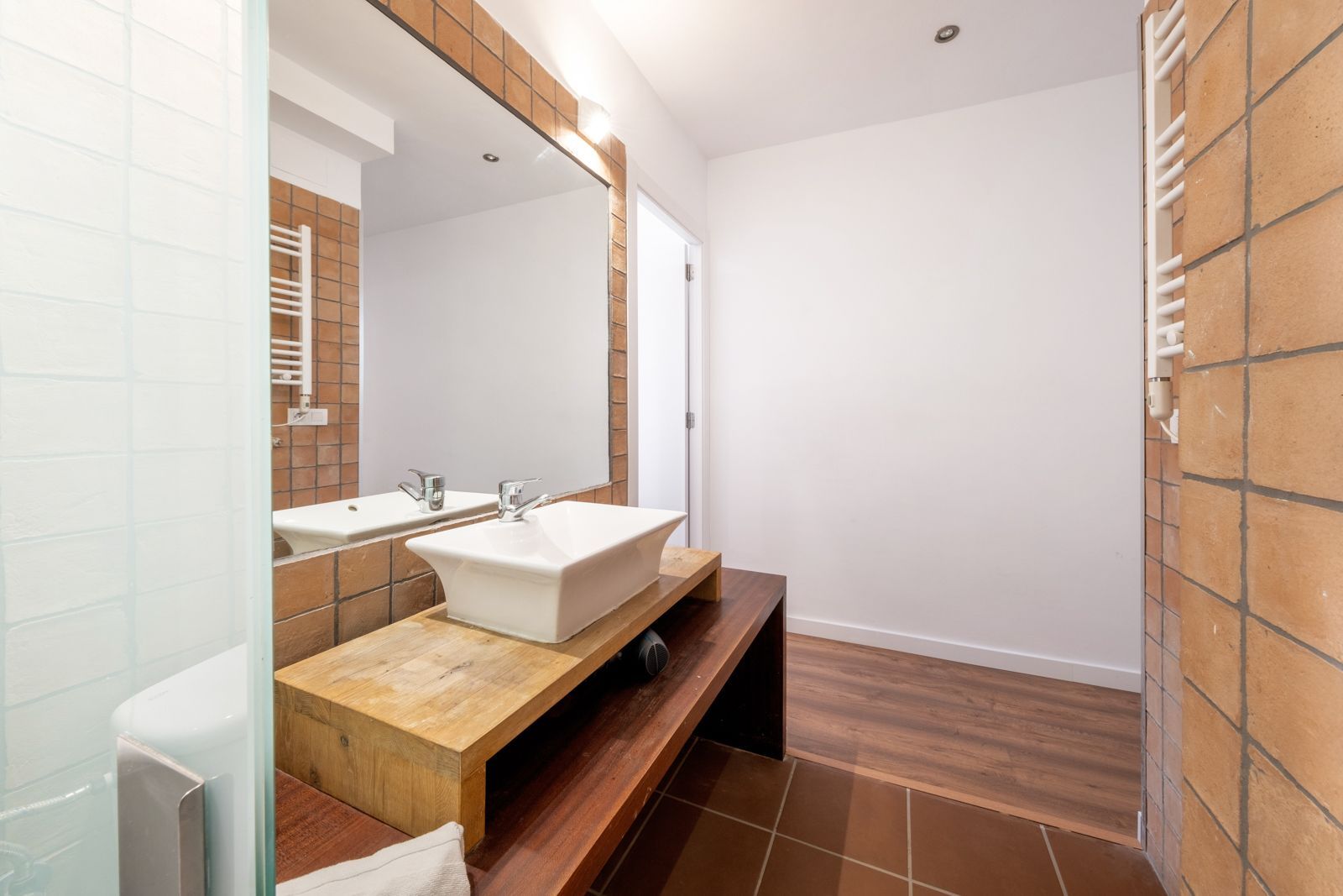 A bathroom with two sinks and a large mirror.