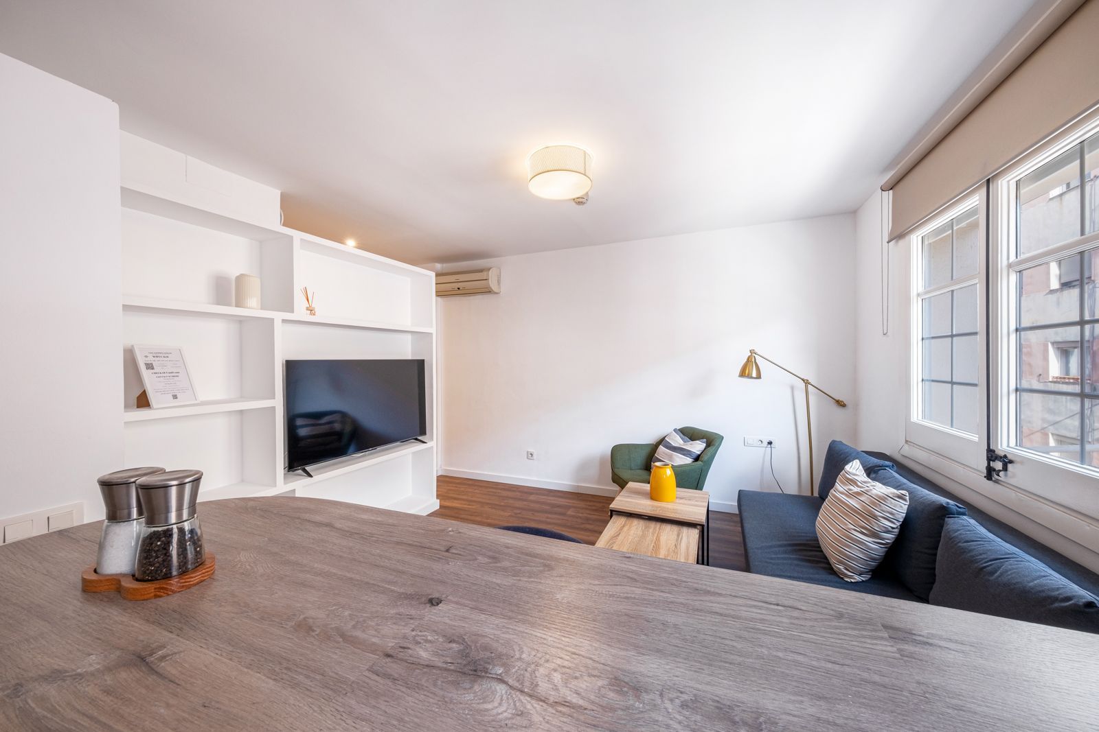 A living room with a couch , table , and television.
