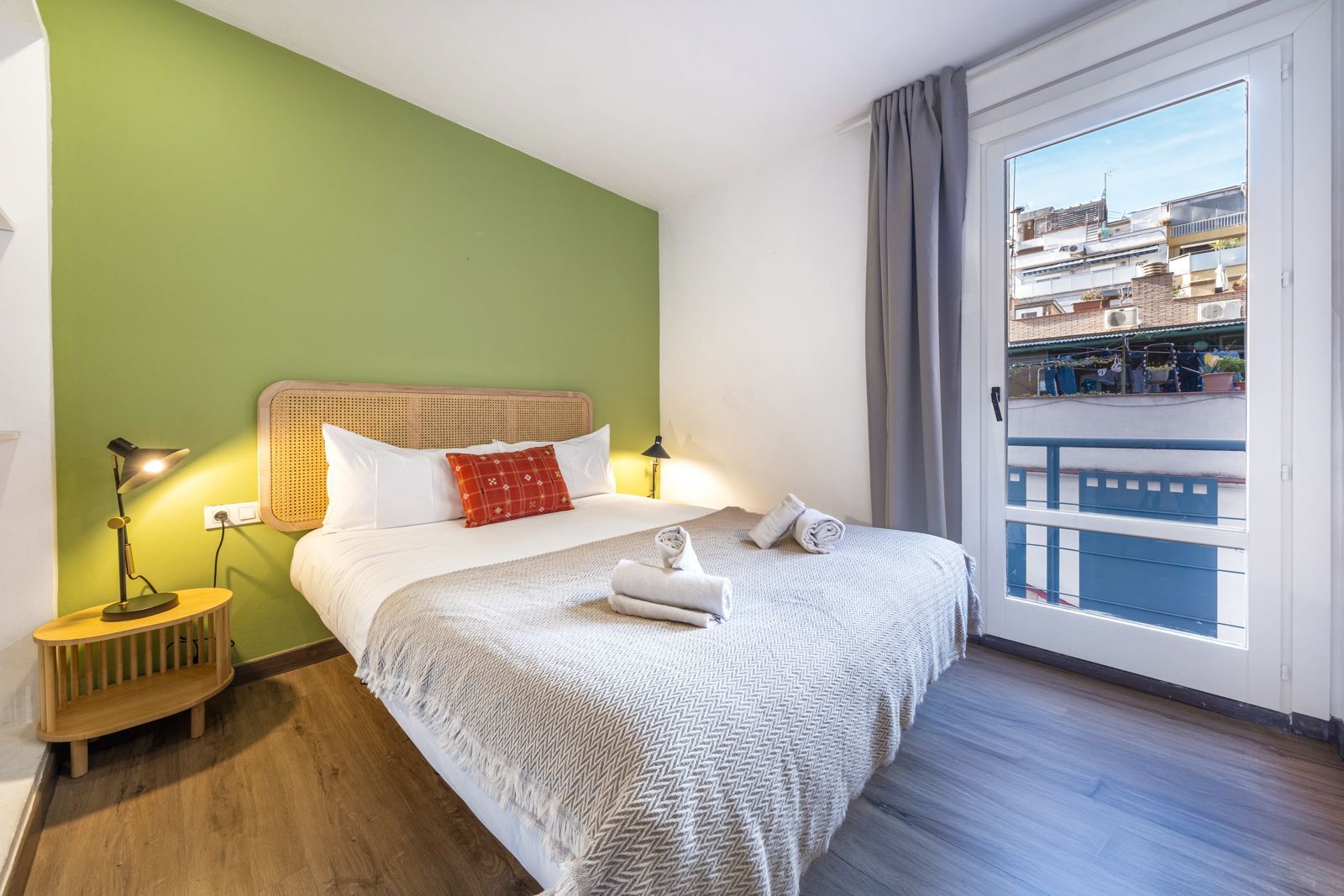 A bedroom with a large bed and a large window.