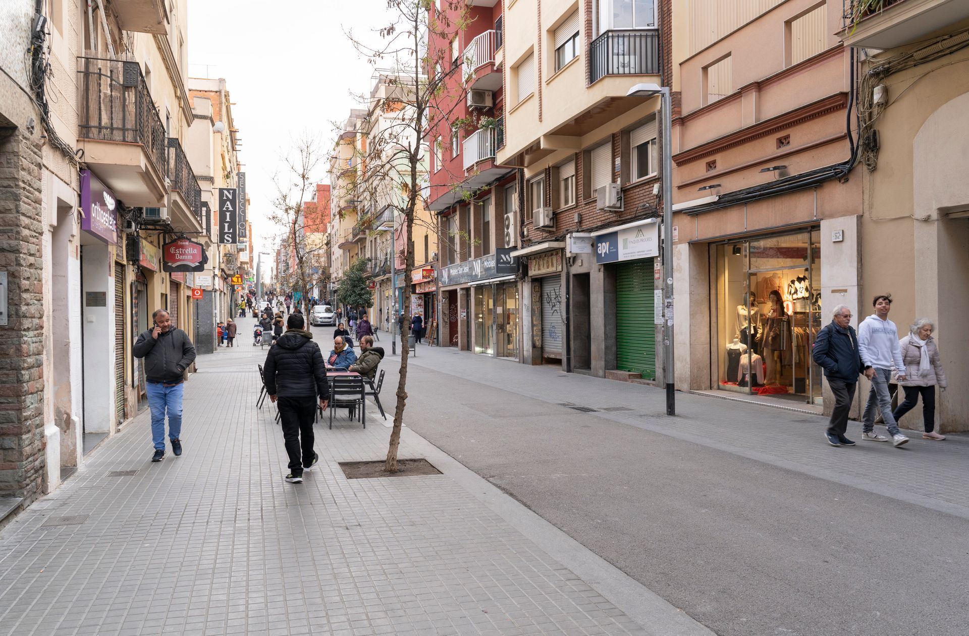 A group of people are walking down a city street.