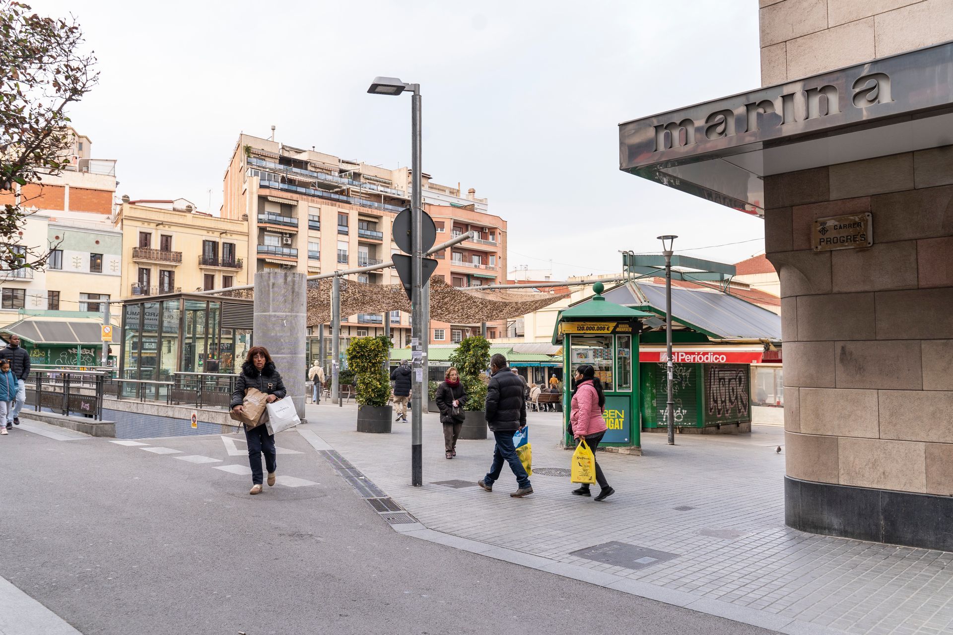 A group of people are walking down a city street.