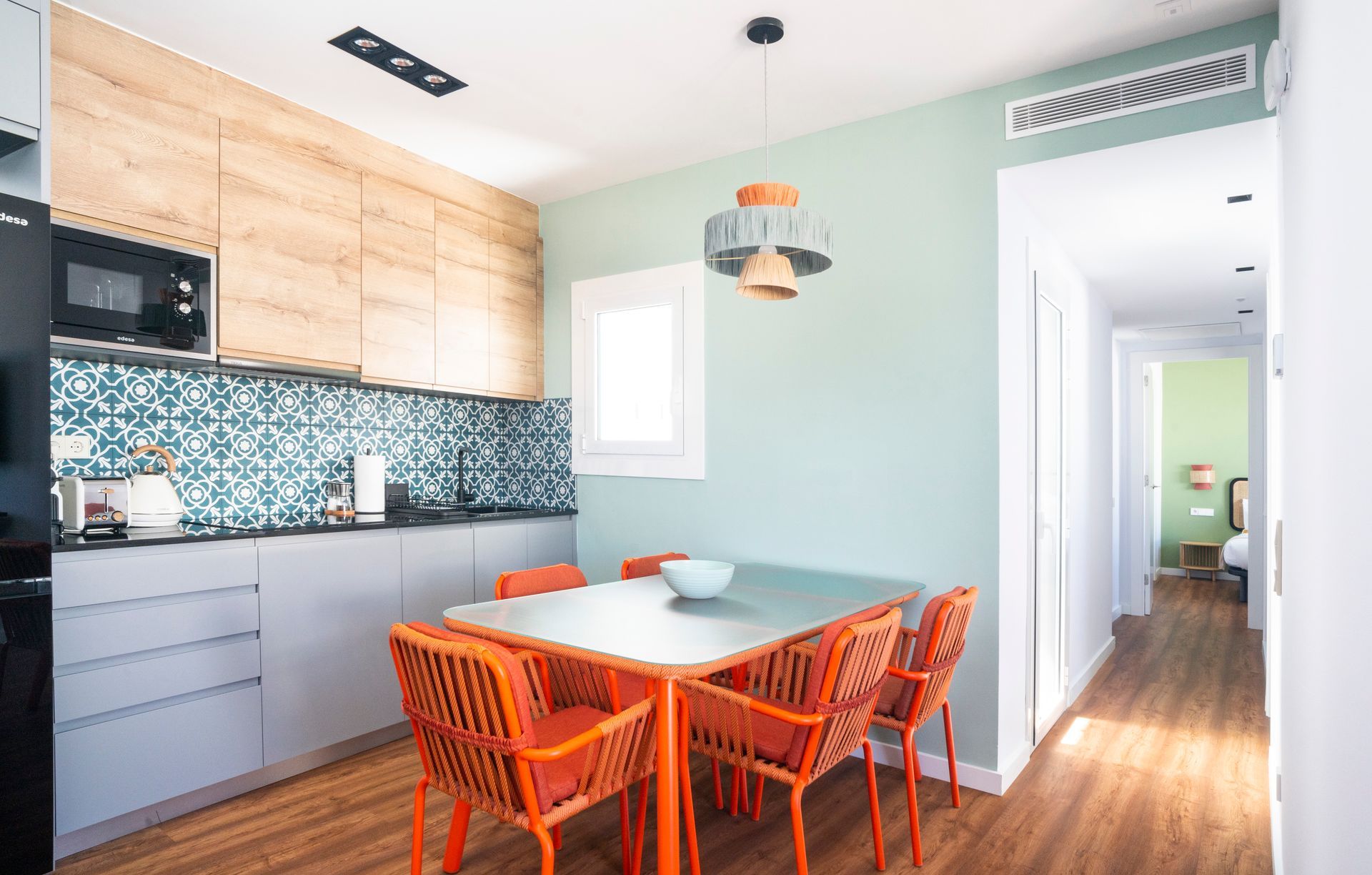 A kitchen with a table and chairs in it