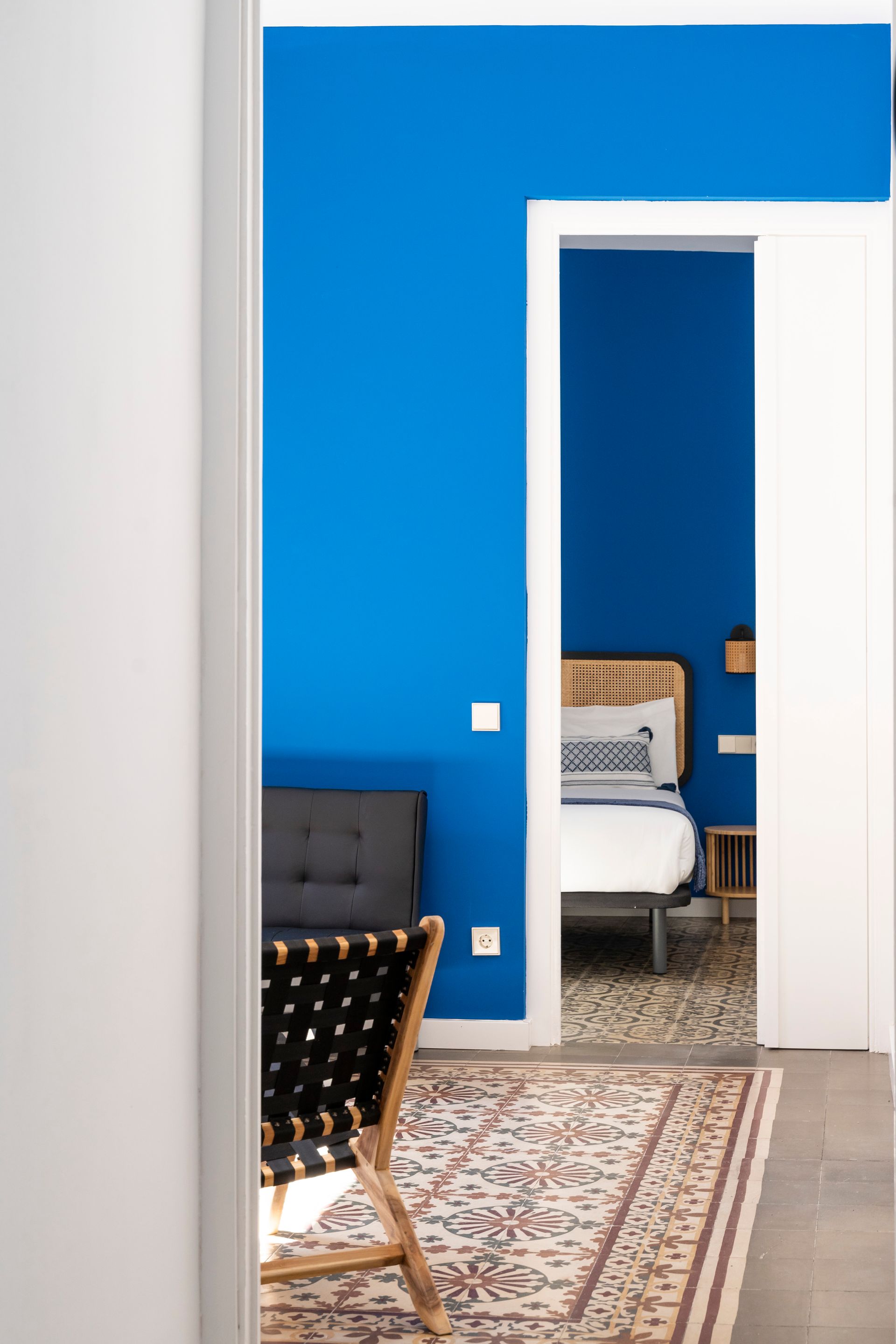 A bedroom with blue walls and a bed in it