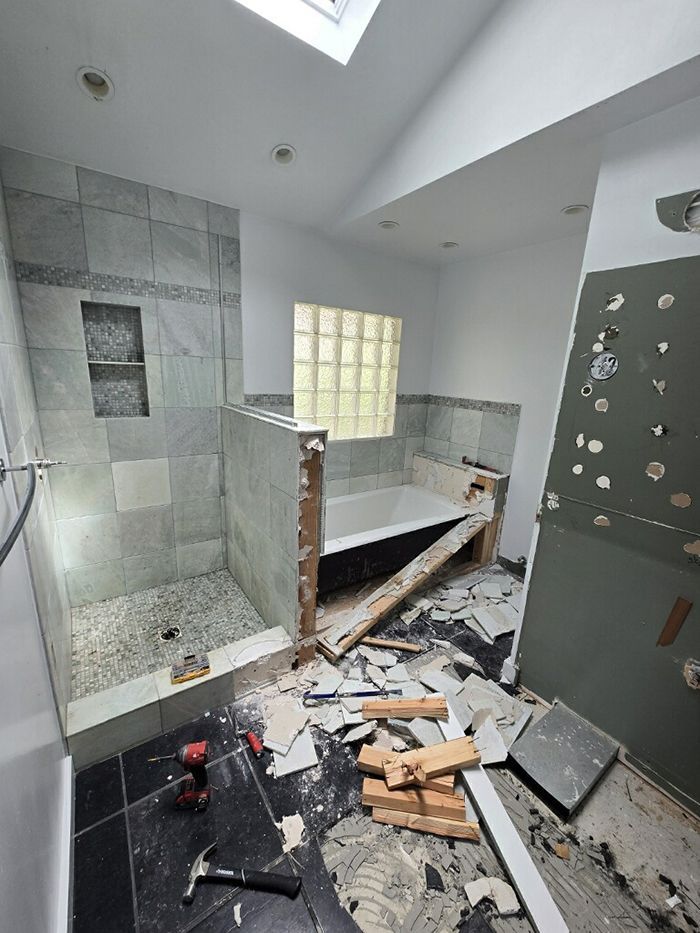 A bathroom under construction with a bathtub and shower.