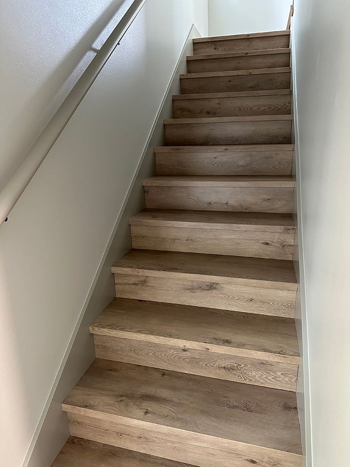 A set of wooden stairs leading up to the second floor of a house.