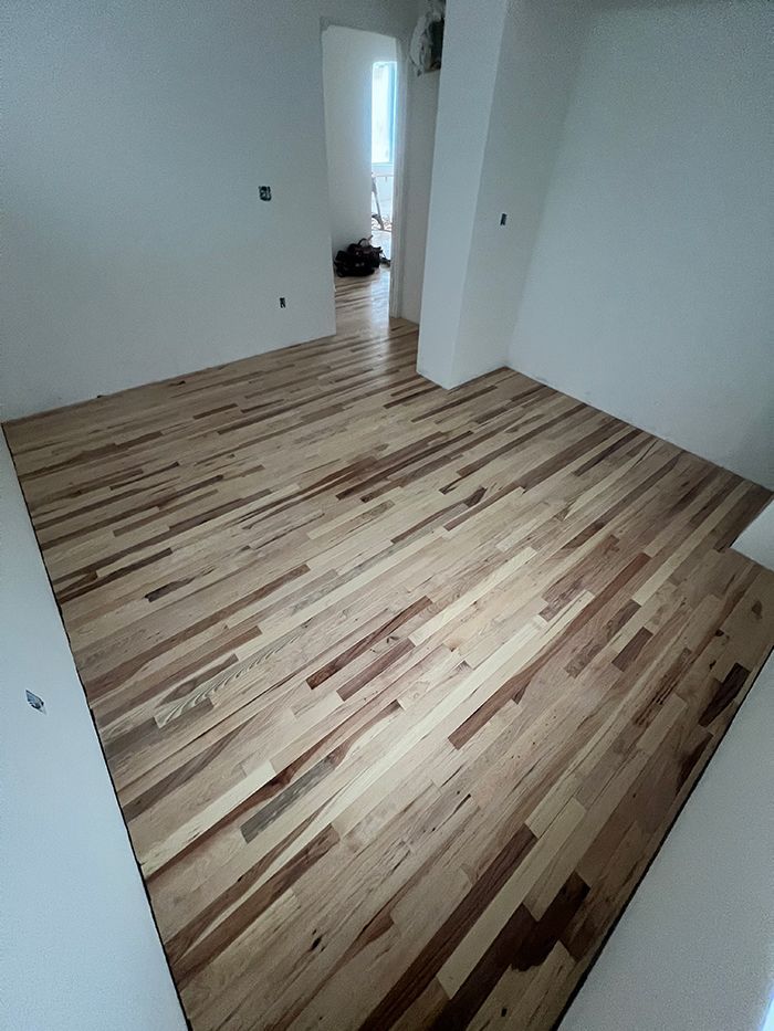 A room with a wooden floor and white walls.