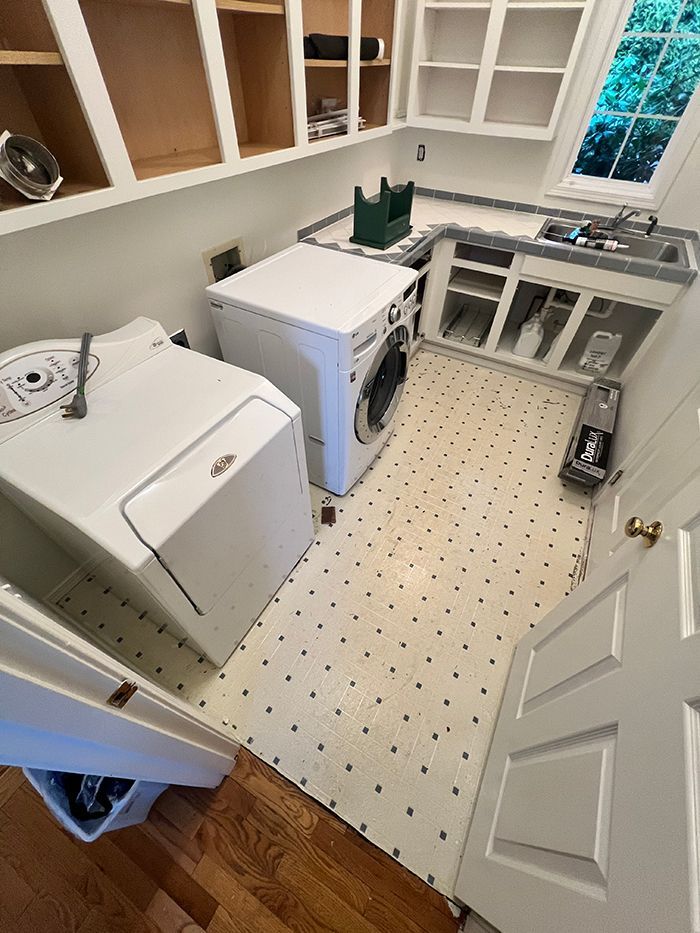 A laundry room with a washer and dryer and a sink.