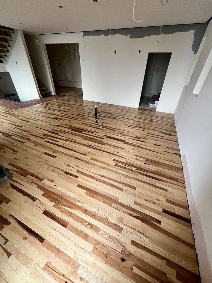 A room with a wooden floor and white walls.