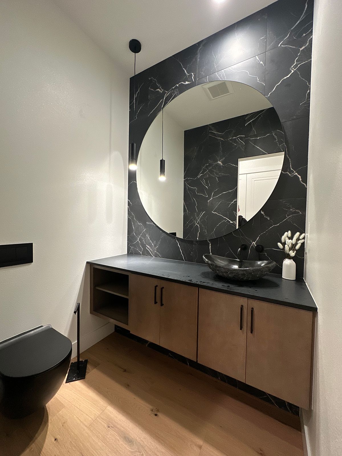 A bathroom with a toilet , sink , and mirror.