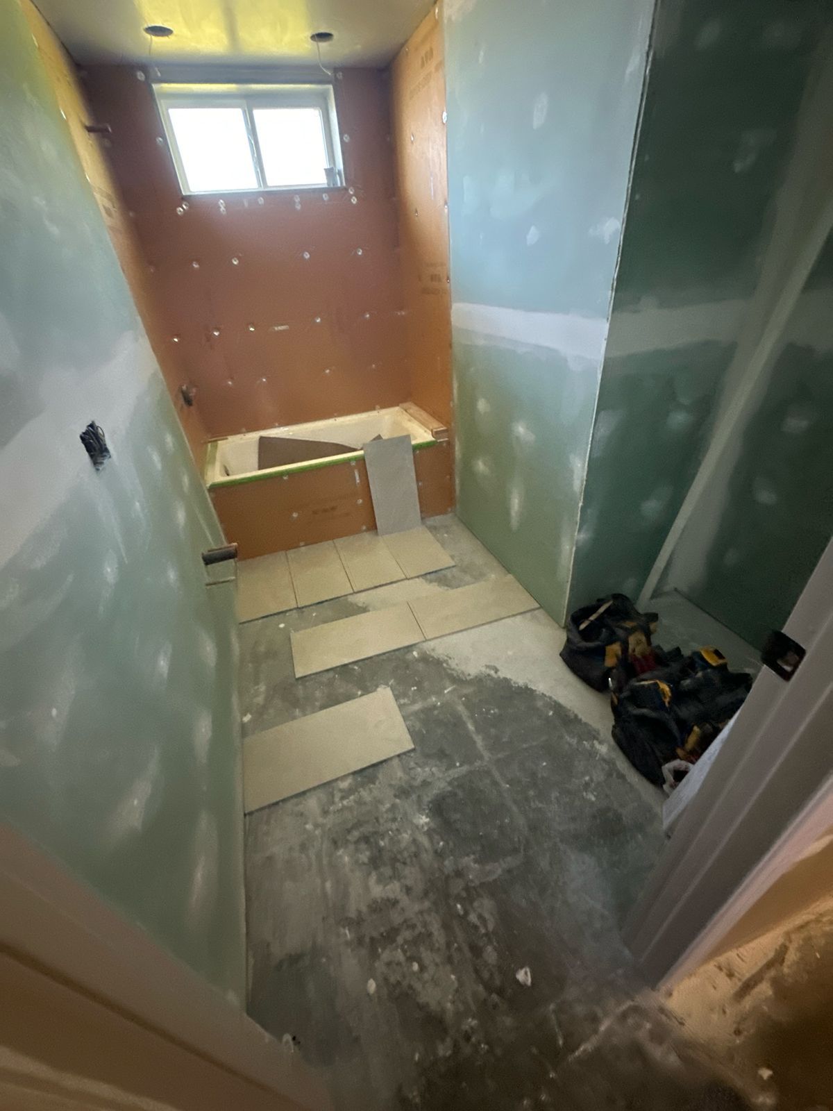 A bathroom under construction with a tub and a shower.