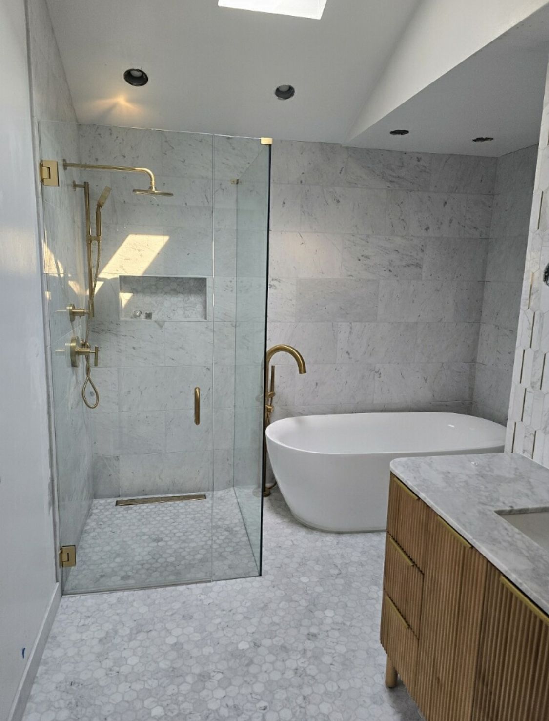 A bathroom with a tub , shower and sink