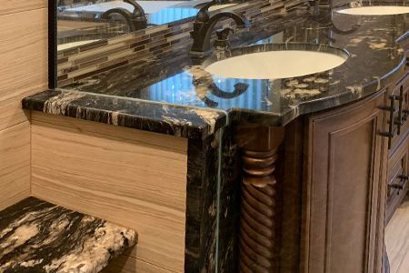 A bathroom with two sinks and a mirror.