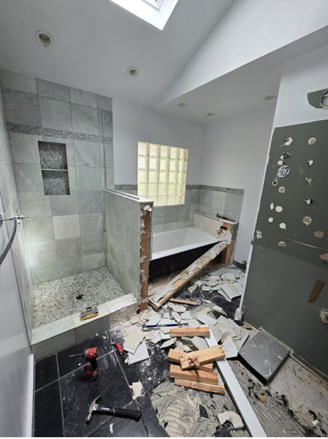 A bathroom under construction with a bathtub and shower.