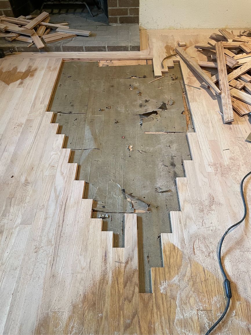 A piece of wood is laying on the floor in a room.