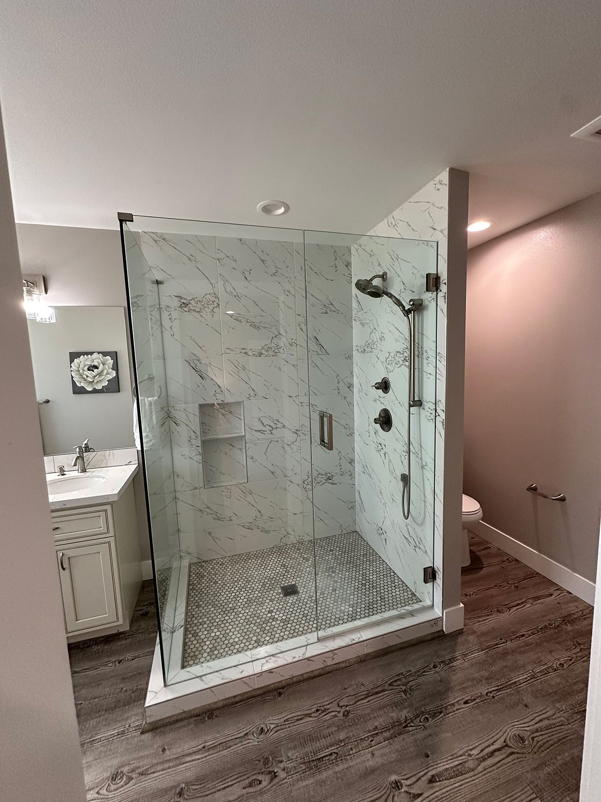 A bathroom with a walk in shower and a toilet.