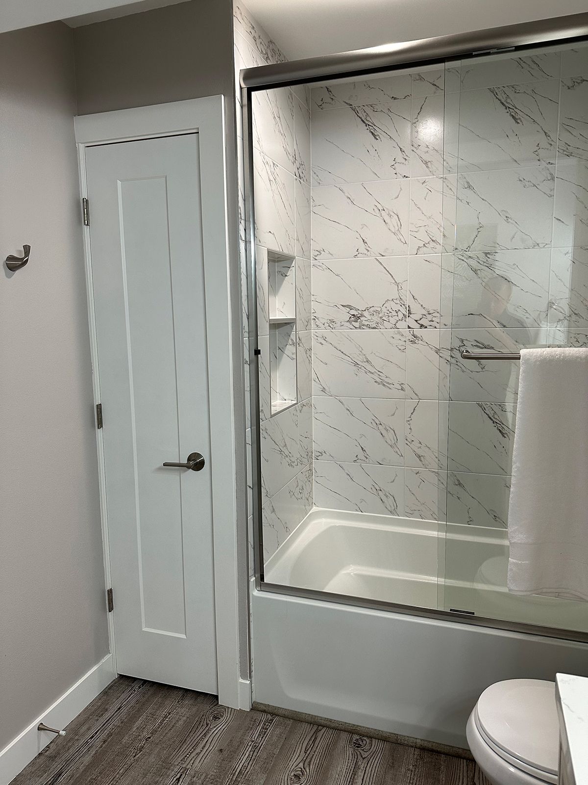 A bathroom with a tub , toilet and shower.