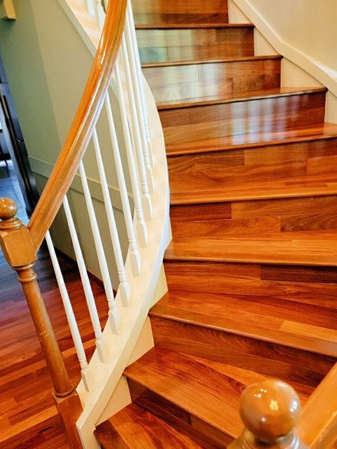 A wooden staircase with a white railing in a house