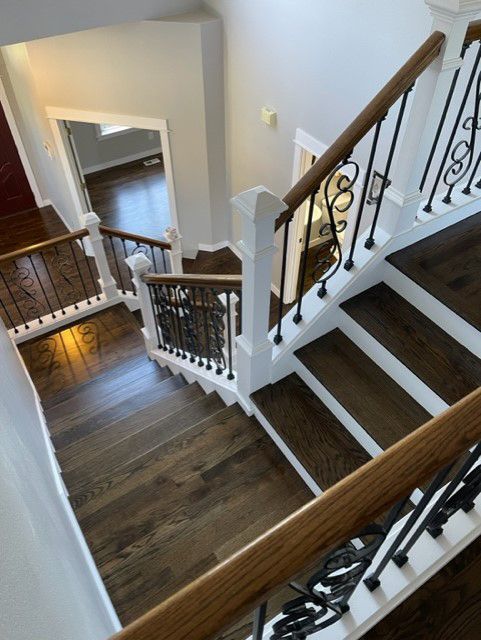 An aerial view of a staircase with a wrought iron railing