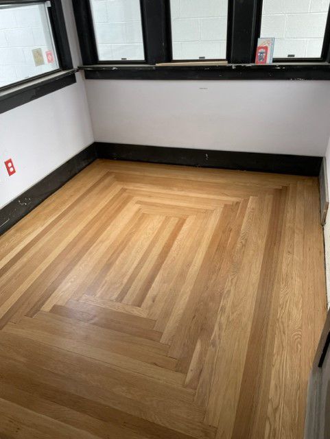 A room with a wooden floor and a window