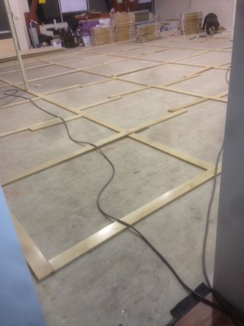 A room with a lot of wooden frames on the floor