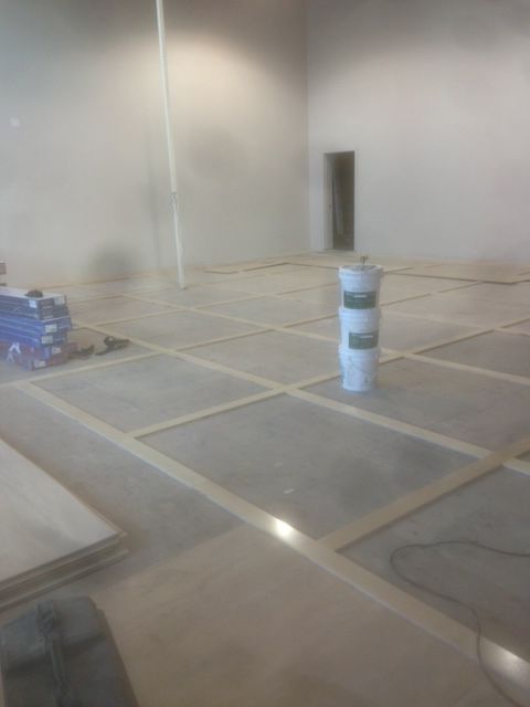 An empty room with a barrel in the middle of it