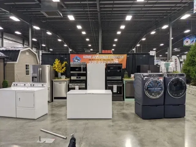 Appliances on display at a store: washers, dryers, fridges, ovens, and dishwashers.