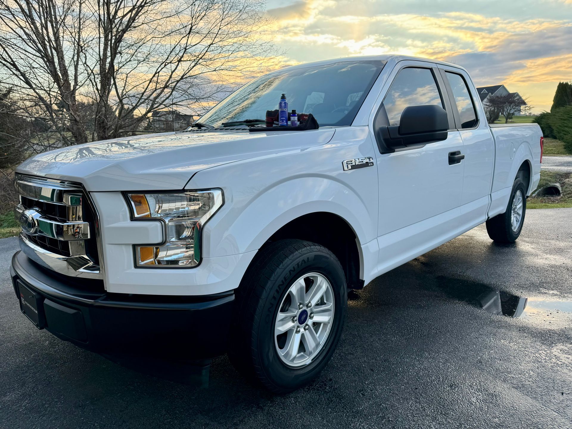 A white ford f150 pickup truck is parked on EG Automotive detailing facility