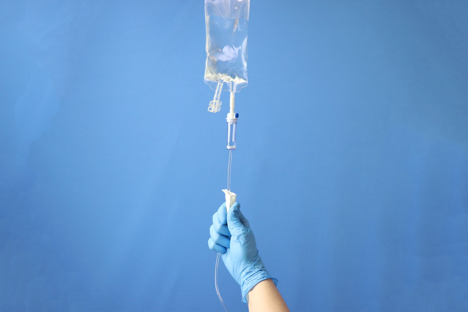 image of a nurse practitioner opening a IV hydration line connected to fluids